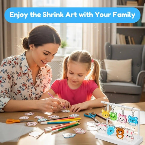 Mother and child using All In One Shrink Plastic Craft Kit For DIY Keychains And Shrink Art With 198 Pieces at a table