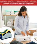 Blue Grey Premium Multi Roll Steel Desk Top Tape Dispenser Holds Three One Inch Tapes Or A Single Three Inch Wide Roll With A Three Inch Core And Up To Five Inch Outer Diameter Built Like A Tank For Your Busy Office shown in a packaging setup