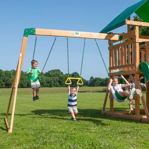 Children playing on Cedar Wood Swing Set With Wave Slide And Elevated Play Deck, Double Rock Wall, Rope Ladder, Web Swing And Belt Swings