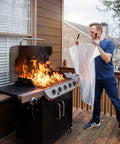 Person using Emergency Fire Blanket 40 By 40 Inches, Woven Fiberglass Fire Shield for smothering grill fire, outdoor safety.