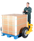 Heavy Duty All Terrain Steel Pallet Truck With Pneumatic Tires And Smooth Steering Glides Over Rough Ground Loads Up To Two Thousand Five Hundred Pounds Without A Sweat On Thirty Two Inch Forks Perfect Yard And Warehouse Workhorse, maneuvering stacked boxes.