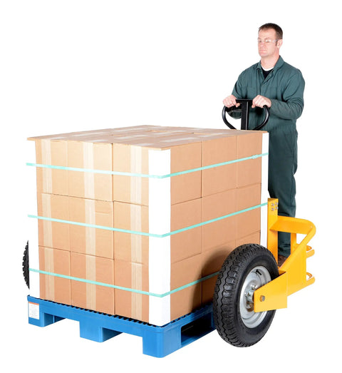 Heavy Duty All Terrain Steel Pallet Truck With Pneumatic Tires And Smooth Steering Glides Over Rough Ground Loads Up To Two Thousand Five Hundred Pounds Without A Sweat On Thirty Two Inch Forks Perfect Yard And Warehouse Workhorse, maneuvering stacked boxes.