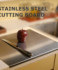 Top view: stainless steel cutting board, 40 x 30 cm, on kitchen counter with knife and apple.