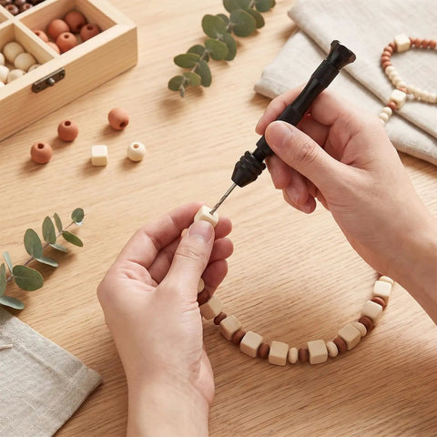 Person using Hardcore Micro Drill Bit Set With Slick Black Pin Vise to work on wooden beads and craft projects.