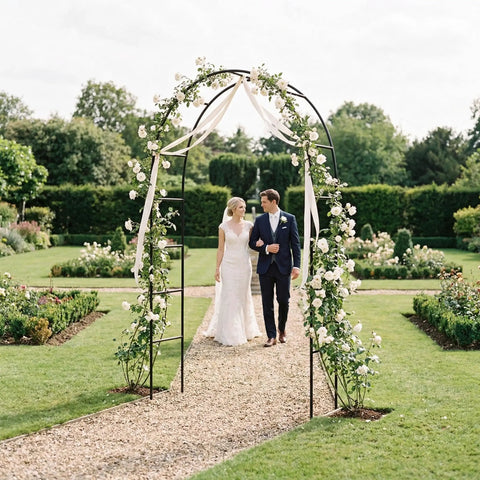 Iron Pergola Garden Arbor For Weddings And Backyards, 7.9 Feet High By 4.6 Feet Wide, arch adorned with flowers and ribbons