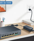 Beefy 48V 3A Power Supply For POE Switch And CCTV Camera, 144W AC/DC Adapter placed next to a network switch on desk