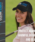 Woman wearing a Clean Flight golf cap, smiling and holding a golf club on a course