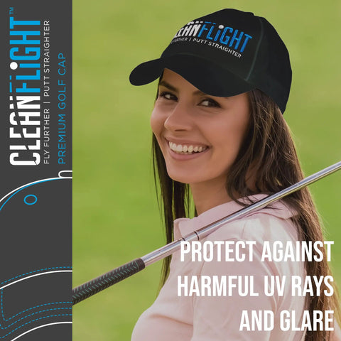 Woman wearing a Clean Flight golf cap, smiling and holding a golf club on a course