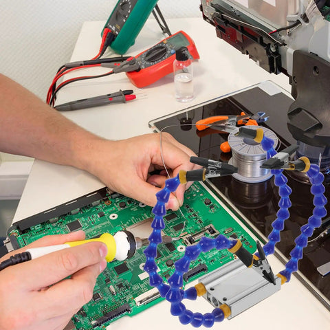 Person using Four Arm Soldering Station With Flexible Joints And Weighted Base Handy PCB Repairing Helping Hands Tool For Electronics Soldering And DIY Projects Portable Easy To Use For Beginners And Pros Alike on a circuit board.