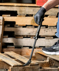 Person using Extendable Pry Bar With 13.3 To 18.5 Inch Reach 14 Position Adjustable Angled Head for leverage on wooden pallets