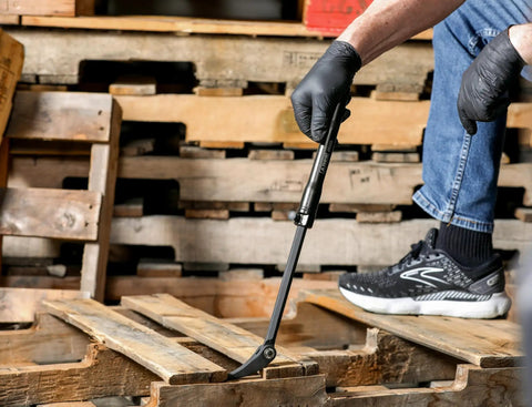 Person using Extendable Pry Bar With 13.3 To 18.5 Inch Reach 14 Position Adjustable Angled Head for leverage on wooden pallets