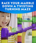Child playing with Glowing Marble Run Kit With 15 Glow-In-The-Dark Glass Marbles And Storage Bag, colorful maze tracks