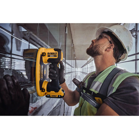 DeWalt 20v Max Cordless Grabo Vacuum Suction Lifter With Built In Pressure Sensor For Heavy Materials Up To 265 Lbs Bare Tool Only held by worker on glass.