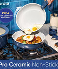 27 Piece Ceramic Nonstick Cookware Set With Detachable Handles featuring blue pan with fried eggs over vegetables on stove.