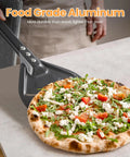 Side view of gray aluminum pizza turning peel lifting a freshly baked pizza.