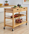 Total Kitchen Upgrade 48 Inch Bamboo Island Cart With Slick Rolling Wheels Double Drawer Units And Spacious Shelves Heavy Duty Wood Prep Table showcasing fruits and vegetables on counter.
