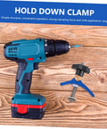 Cordless drill and heavy duty track hold down clamp for woodworking on wooden background