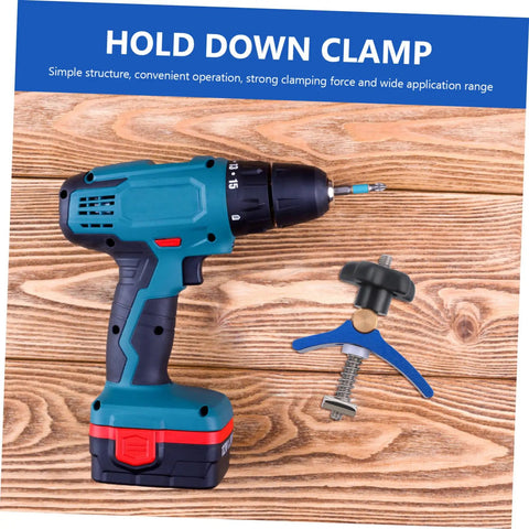 Cordless drill and heavy duty track hold down clamp for woodworking on wooden background