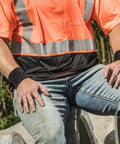 Person wearing black terry cloth wrist sweatbands for adults, thick absorbent cotton, unisex pair, working outdoors.
