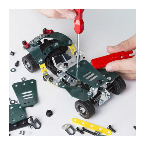 Building Roadster 5-In-1 kit with metal parts; demonstrating assembly of pull-back racer for kids, ages 8+, in STEM education.