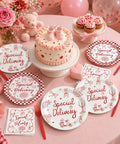 96 Piece Special Delivery Pizza Paper Plates And Napkins Set Hits Different With Chic Red White Checkered Prints For Italian Theme Baby Shower Neutral Gender Reveal Birthday Parties on display with cake and flowers.