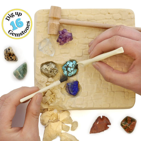 Hands using tools to uncover gems from Gem Stone Dig Kit With 16 Real Gems And Crystals Including Quartz Point And Amethyst STEM Education