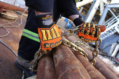 KONG SDX2 05 XL Oil And Gas Safety Impact Gloves Orange Heavy Duty Work Gloves worn while handling chains in an industrial setting