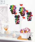 Flower Scratch Card Craft Kit For Kids Featuring 60 Cards In Two Styles With 20 Wooden Styluses And Pink Ribbon Ideal For Mother's Day Teacher Appreciation Gift Classroom Or Home Fun displayed on a table with decorations.