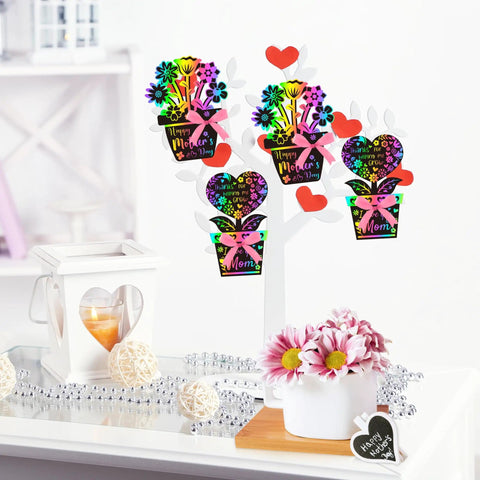 Flower Scratch Card Craft Kit For Kids Featuring 60 Cards In Two Styles With 20 Wooden Styluses And Pink Ribbon Ideal For Mother's Day Teacher Appreciation Gift Classroom Or Home Fun displayed on a table with decorations.