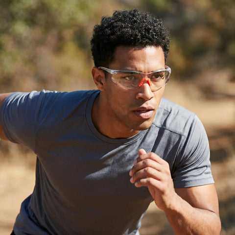 Man wearing Badass Silicone Safety Glasses For Construction Work, shatterproof polycarbonate lenses, while running outdoors.