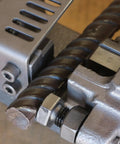 Close-up of Heavy Duty Portable Electric Hydraulic Rebar Cutter cutting a one inch steel bar with precision.