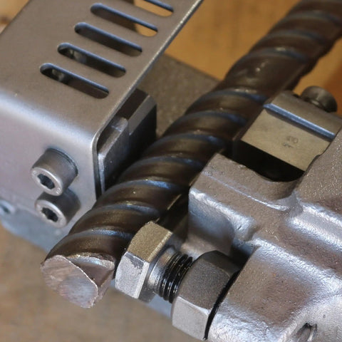 Close-up of Heavy Duty Portable Electric Hydraulic Rebar Cutter cutting a one inch steel bar with precision.