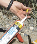 Hand demonstrating Reusable Caulk Tube Cap With Built In Puncture Pin 2 Pack Keep Caulk Fresh Between Jobs Seals Open Tubes Tight And Prevent Dry Out Pro Grade Caulk Saver For Home Renovations And DIY Projects outdoors