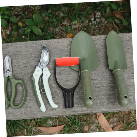 Two Piece Plastic D Shaped Shovel Handle Replacement next to garden tools on a wooden bench