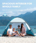 Family seated inside Four Person Beach Tent With Easy Pop Up Setup Shade Shelter at beach, featuring durable fiberglass frame and UV protection.