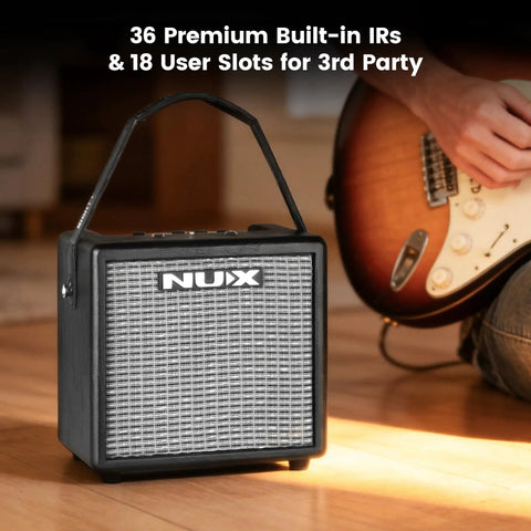 Mighty 8BT MKII 8W Portable Modeling Amp next to acoustic electric guitar with FRFR speaker and Bluetooth features.