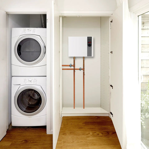 Score Instant Hot Water With This Beast-Mode 26.9 KW Electric Tankless Water Heater mounted beside a stacked washer and dryer.