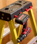 Rugged Tape Measure Holder For Garage Organization, Keeps Tools Handy On Ladder Or Workbench, Grab-And-Go Quick Install Tool Hook Pack Of 4, Built To Last, Versatile, Yellow attached to ladder with drill hung on it