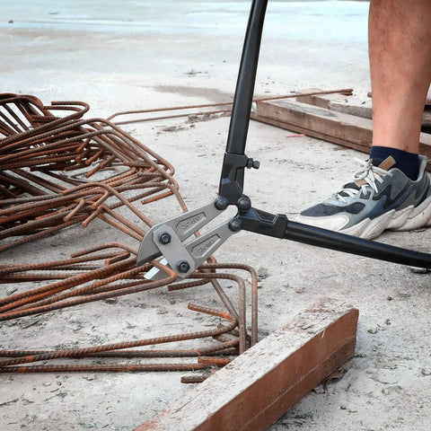 Cutting rebar with Beefy 24 Inch Bolt Cutter With Chrome Molybdenum Steel Jaws in construction site.