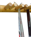Built Tough Game Changing Heavy Duty Solid Wood Log Style Wall Mount Ski Rack Holds Six Pairs Of Skis And Poles Indoor Garage Wall Space Saver Organizer Rack Natural Finish with two skis hanging.