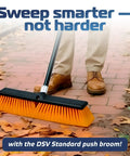 Person using Heavy Duty Workhorse 18 Inch Push Broom With Extended Handle And Tough Six Row Bristles on outdoor patio.