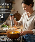 Workhorse Immersion Blender With 1200W Motor Four Blade Stainless Steel Mixing Wand in pot blending thick soup.