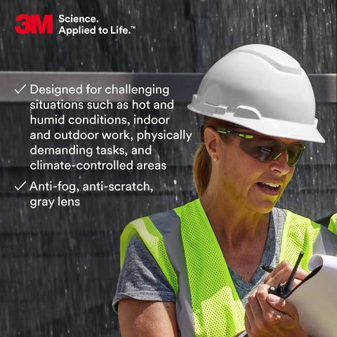 Worker wearing Solus 1000 Safety Glasses with Scotchgard Anti Fog Coating, gray lenses, green black frame, padded temples.