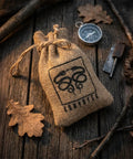 English Flint Fire Starter Kit With Two Large UK Flint Stones And Emergency Jute Tinder Bag for bushcraft on wooden surface