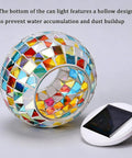 Mosaic solar globe lamp with color changing glass, auto on/off feature, next to its solar panel for outdoor and indoor decor.