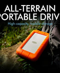 Rugged USB C 4TB Portable External Drive With Drop, Shock, Dust And Rain Resistance for Mac and PC on log outdoors