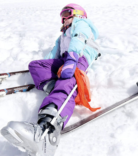 Child skiing on snow wearing ski gear with orange Yosemite Map Survival Bandana And Grab-and-Go Emergency Navigation Scarf.