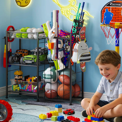 All In One Sports Gear Organizer Cart With Elastic Straps And Removable Basket For Garage Organization, Ball Storage Rack For Basketballs Soccer Balls And More, Hooks For Toy Gear Storage, Black holding sports balls, toy cars, and gear in playroom.