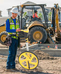 Tough Foldable Digital Measuring Wheel With Telescopic Shaft And Sweet Backlit Readout Includes Compact Tape Measure in use on construction site.