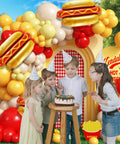 Barbecue Balloon Garland Arch Kit With 176 Pcs Red Yellow White Balloons And Hot Dog Foil Balloons For Picnic Baby Shower Party Decor Easy DIY Arch That Sparks Fun Grillside Celebrations Indoors Or Outdoors with children in party hats.